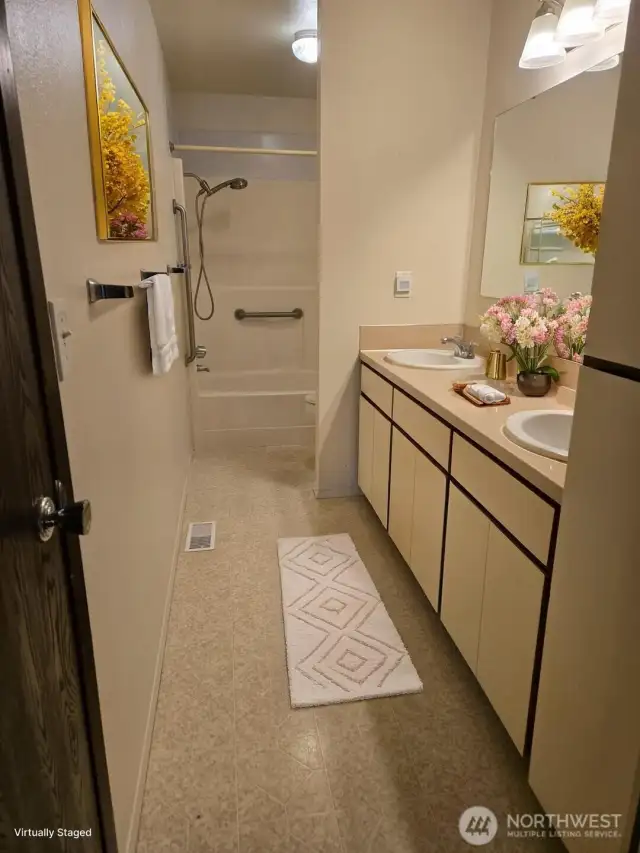 staged photo representing bathrooms of all units, double sink vanities, shower tub combo.