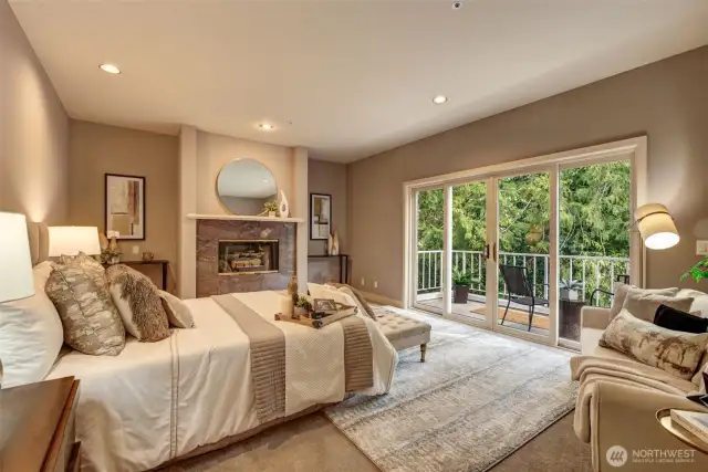 Unwind in the generously sized primary suite with gas fireplace and beautiful view of the trees.