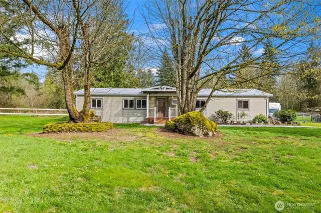 Mature landscaping including beautiful trees and flowers