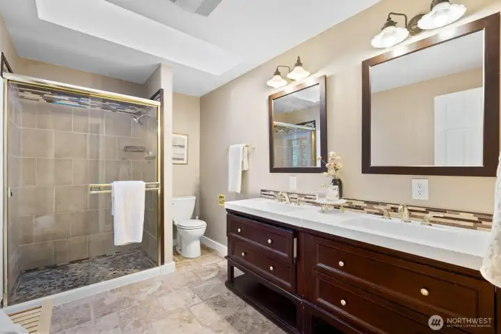PRIMARY BATHROOM WITH DOUBLE VANITIES, CERAMIC TILE FLOOR, FRESH PAINT WITH TILE SHOWER AND CUSTOM FLOOR AND NEW PVC TRIM