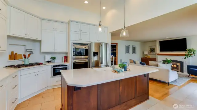 Equipped with new pristine white cabinetry offering abundant storage, a double oven, and all appliances included for your convenience