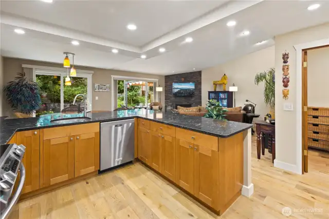 Stylish and functional, the kitchen is a true centerpiece of the home, perfect for both everyday living and entertaining. Featuring solid wood cabinetry, gleaming black granite countertops, and stainless-steel appliances.