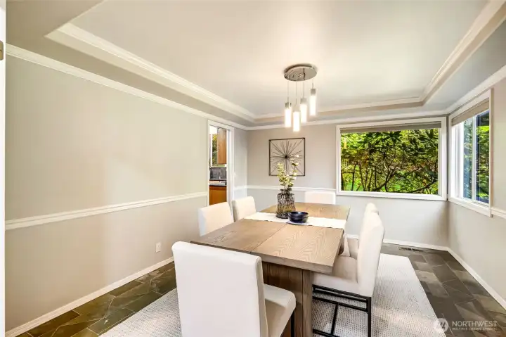 The formal dining room with coffered ceiling sets the scene for unforgettable meals with family and friends.