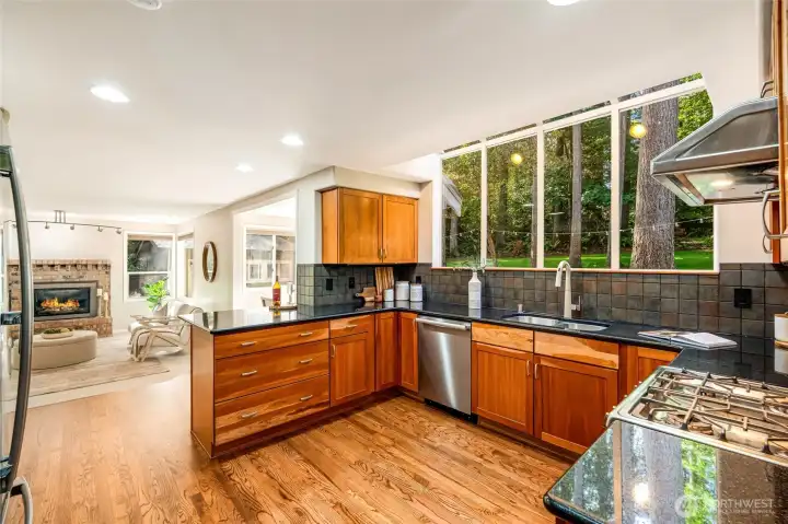 The chef’s kitchen is a masterpiece, with granite countertops, custom Shaker cherry cabinetry, and stainless steel appliances.
