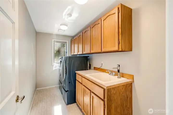 Thoughtfully designed utility space and convenient half bath complete the main level, seamlessly combining style and function.