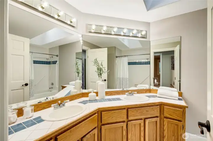 Beautifully appointed full bath with a skylight that fills the room with natural light.