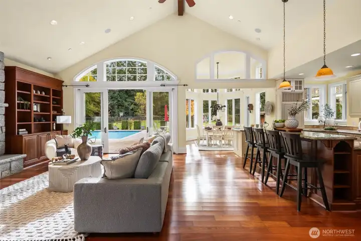 Large Great Room Kitchen with vaulted ceilings, nook, massive island and large double slider to poolside living