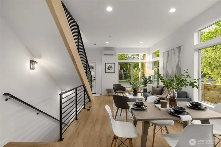 A dramatic staircase and airy ceilings anchor the main living level, adding both function and modern architectural flair.