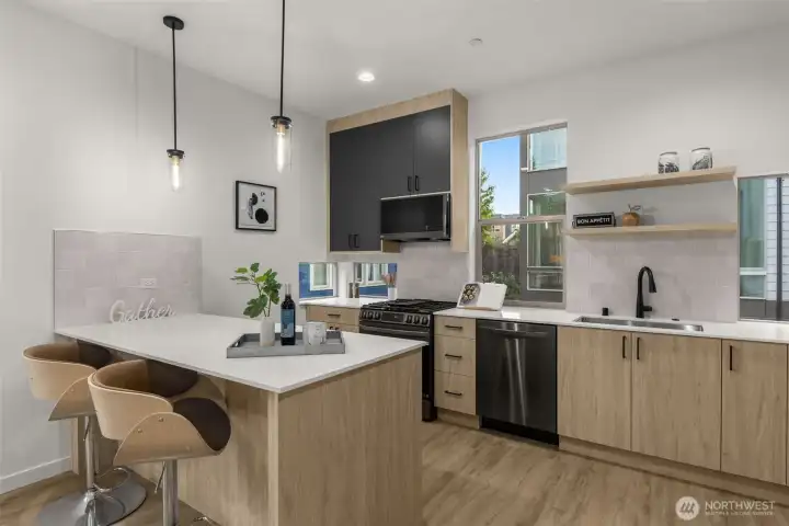 The chef’s kitchen shines with quartz countertops, pendant lighting, and sleek cabinetry that maximizes storage.