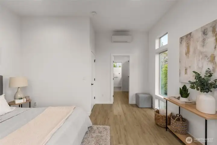 A bright, airy hallway leads to private bathroom, offering quiet separation from the main bedroom space.