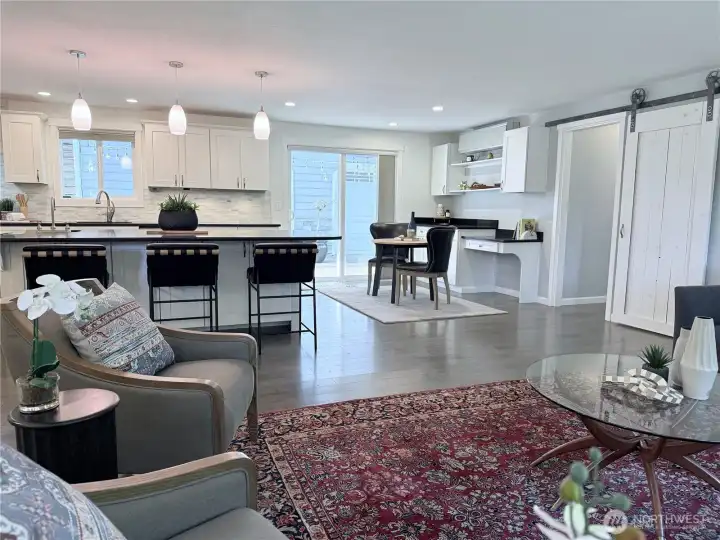Barn door leads to laundry room and primary bedroom