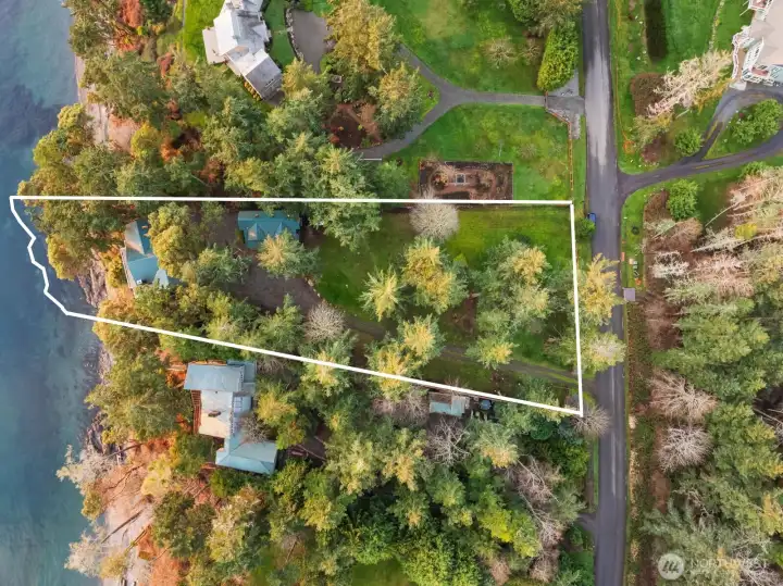 Approximate boundary lines illustrate the scale and positioning of this coveted west-facing waterfront property.