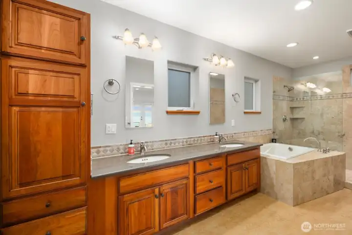 Elegant ensuite with soaking tub, dual vanities, and walk-in shower designed for relaxation and comfort.