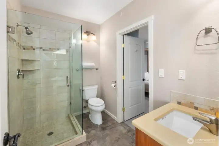 Stylish guest bath featuring glass-enclosed shower, modern fixtures, and clean, contemporary finishes.