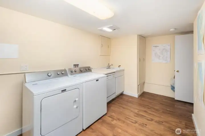 Spacious laundry area with storage and workspace, designed for convenience without compromising style.