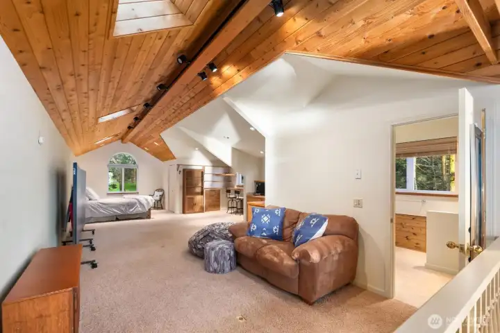 Vaulted-ceiling studio apartment providing versatile guest space or creative retreat with island charm.