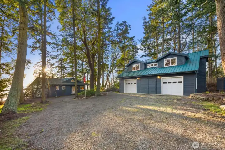 Detached multi-bay garage with studio apartment above, offering versatile guest space, creative use, or extended-stay flexibility.