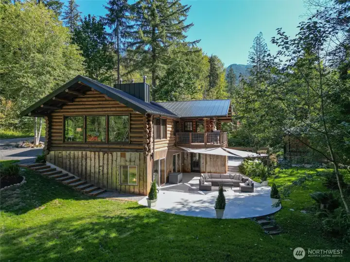 Cedar Logs from Church Mountain, Corten steel siding and medal roof. Sunny backyard and patio.