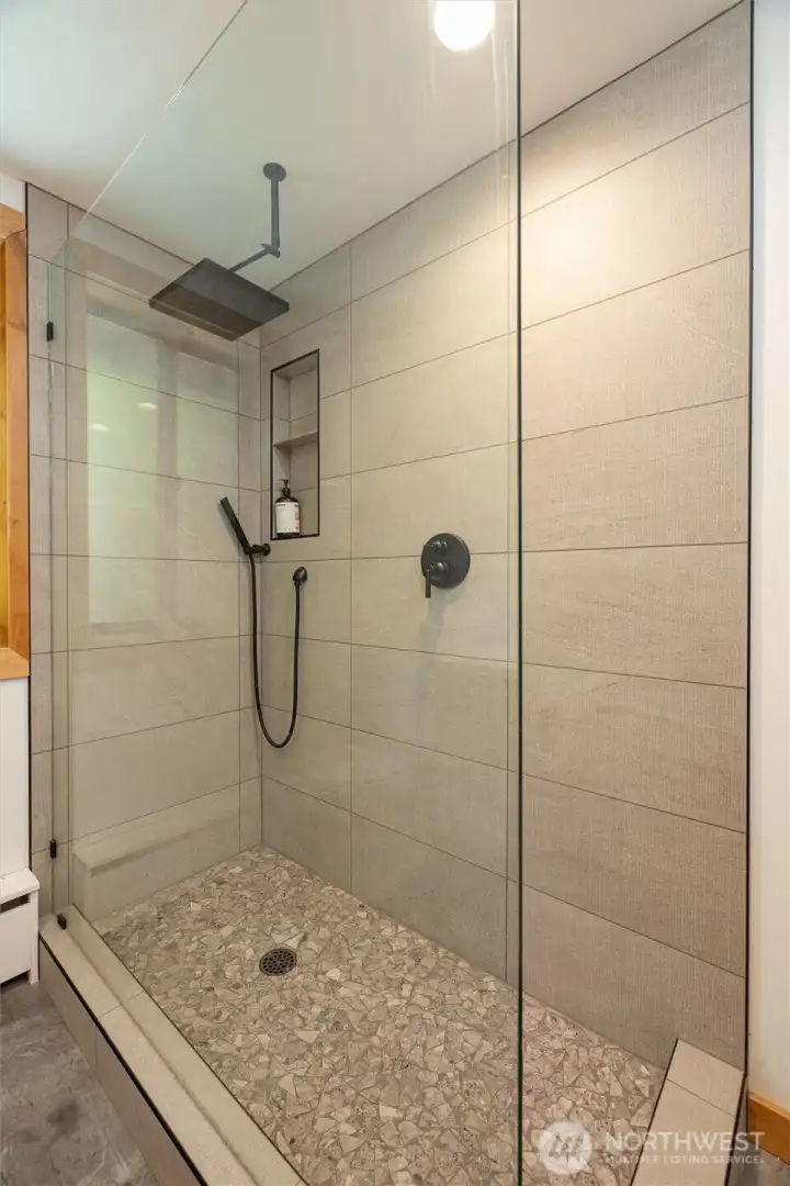 Spacious main floor bathroom shower with rain shower head.