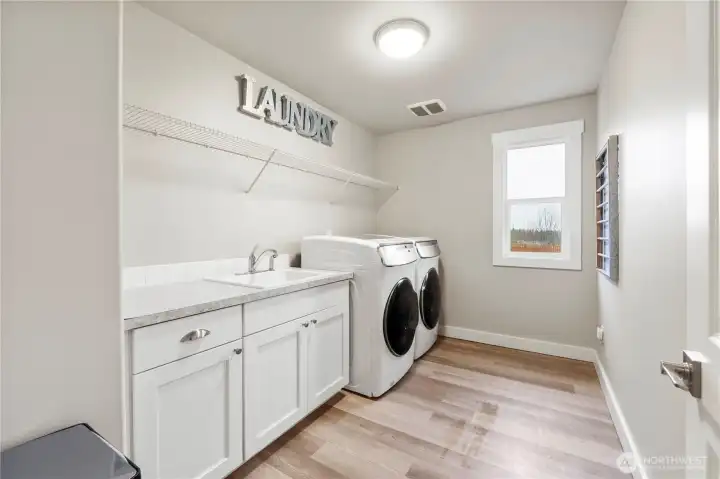 Large laundry room with utility sink and counter