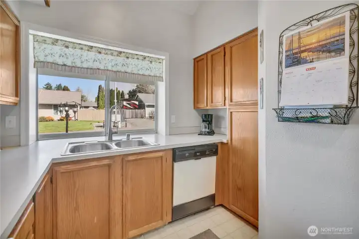 The kitchen with window views bringing in natural light.