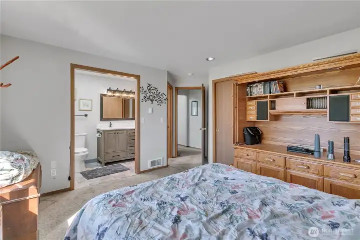 Here is another view of the primary bedroom looking into the adjacent remodeled bathroom. The walk-in closet is on the right as you enter the room.