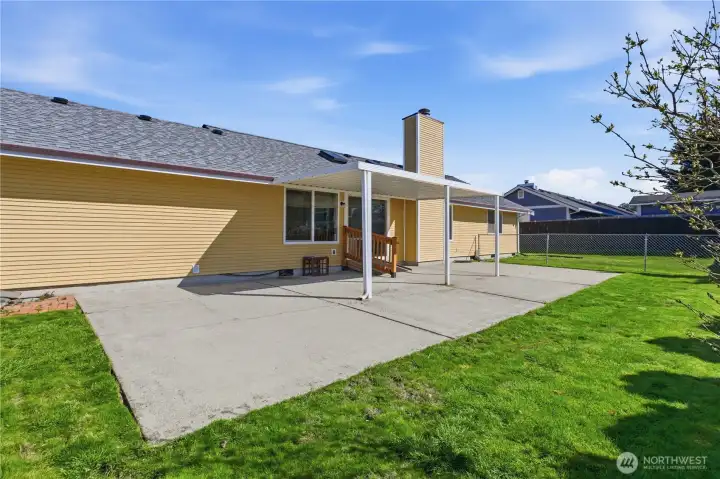 Another view of the fully fenced backyard, large patio and beautiful lawn--just in time for warm weather entertaining!