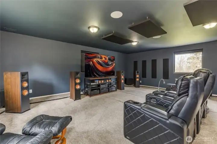 The Crown Jewel: A professionally sound-proofed, custom-installed home theater system that must be heard to be believed. Enjoy the cinematic excellence featuring a top-of-the-line 83" Sony OLED UHD TV and a massive 17-speaker Klipsch & REL surround system.