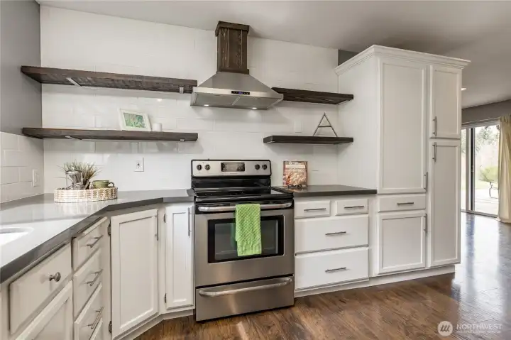 Smart kitchen design featuring elegant open shelving for a custom feel, paired with a corner lazy Susan to maximize storage and accessibility