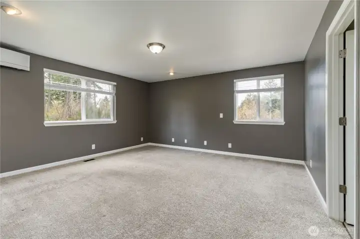 Expansive main-floor primary suite serves as a private retreat, complete with its own dedicated mini-split system for personalized comfort