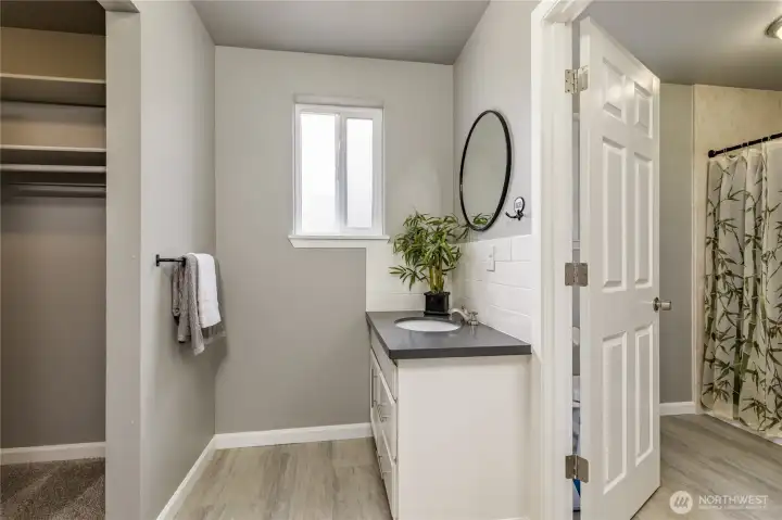 Thoughtfully designed primary bath with walk-in closet and dual vanities