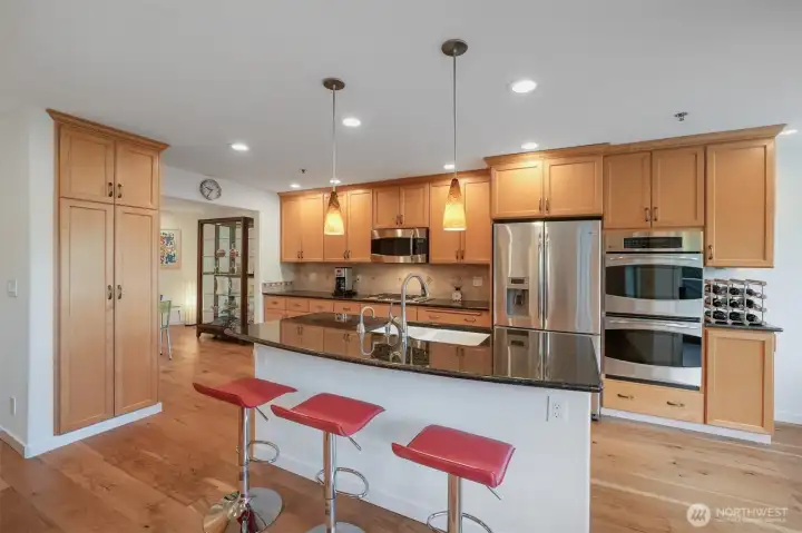 Chef-inspired kitchen with granite countertops. GE Profile Series appliances elevate the culinary experience.