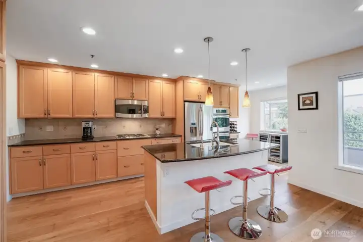 Spacious cooking island with breakfast bar seating.