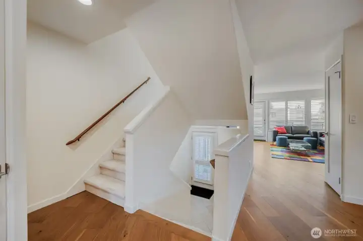 2nd level. Stairs up to primary bedroom with private bath and additional bedroom with full bath. Stairs down to the bedroom or den.