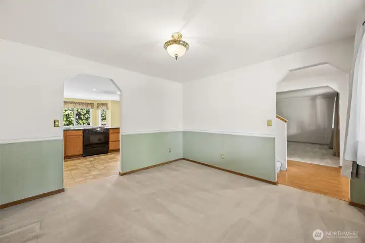 Centrally located formal dining room welcomes guests from the moment they enter, offering seamless access to the kitchen for effortless entertaining and everyday convenience.