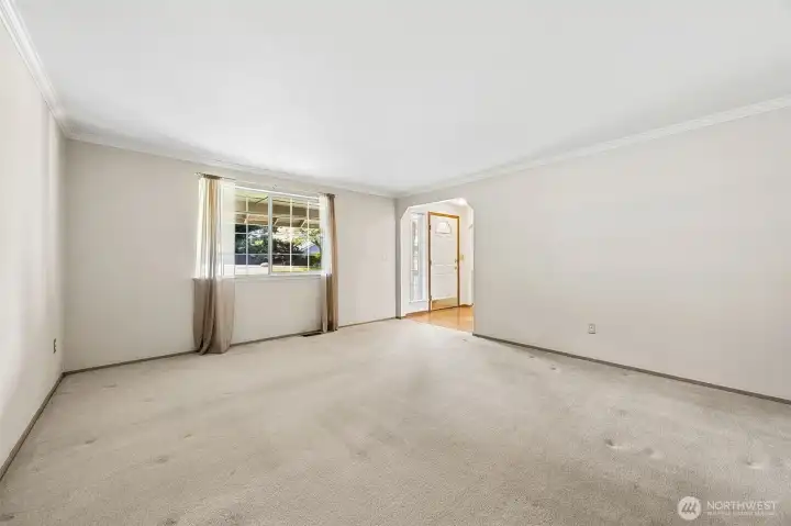 Formal living area just off the entry sets an elegant tone, offering a refined space ideal for greeting guests or quiet relaxation.