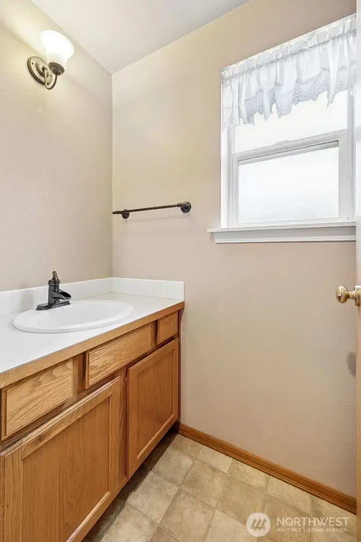 1/2 bathroom located on the main floor just off the kitchen nook.