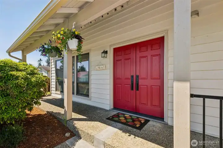 Great curb appeal starts here—gorgeous double entry doors and a covered front porch offer a warm and inviting welcome.