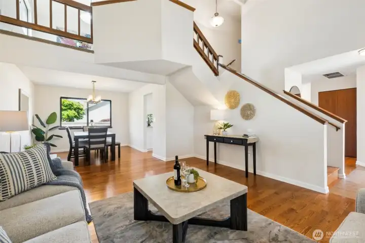 A dramatic open staircase, loft overlook, and expansive hardwood floors combine to create a bright, airy interior with timeless appeal.