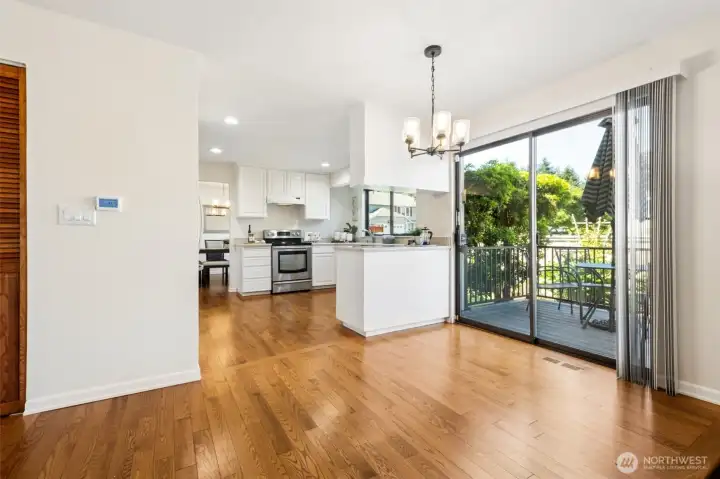 Sunny informal dining area with updated lighting and sliding glass door access to the backyard deck—is perfect for morning coffee, casual dining, and easy BBQ entertaining.