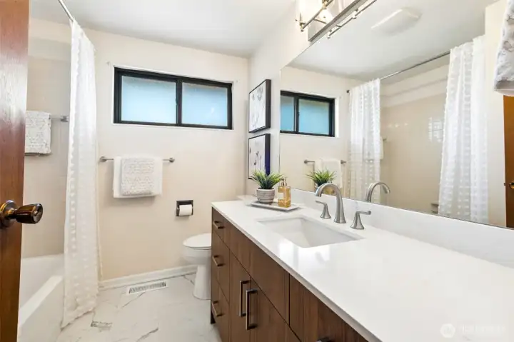 Beautifully updated upper hall bath featuring stylish finishes, modern fixtures, and a fresh, contemporary design.