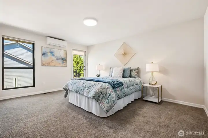 Spacious primary suite featuring private access to the refreshed upper deck—an ideal spot for morning coffee or unwinding at day's end.