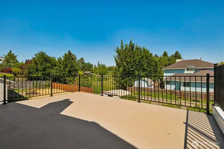 Expansive upper deck offers a wonderful outdoor retreat with neighborhood views and plenty of room for lounging, entertaining, or soaking up the sunshine.