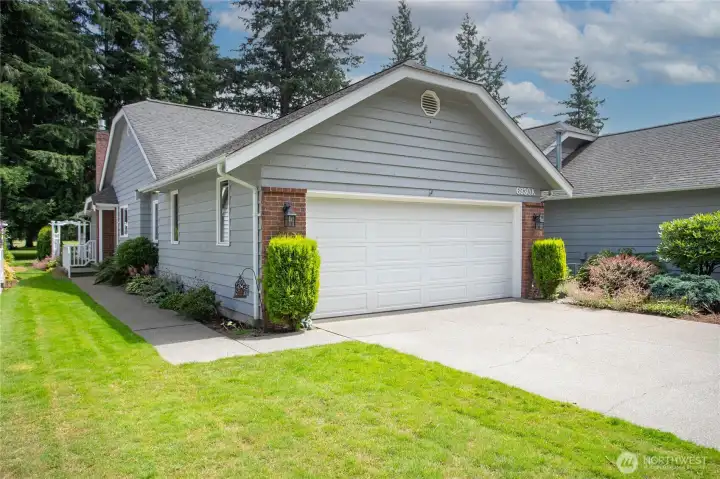 2 car attached garage with sidewalk leading to front entry 2 car attached garage with sidewalk leading to front entry