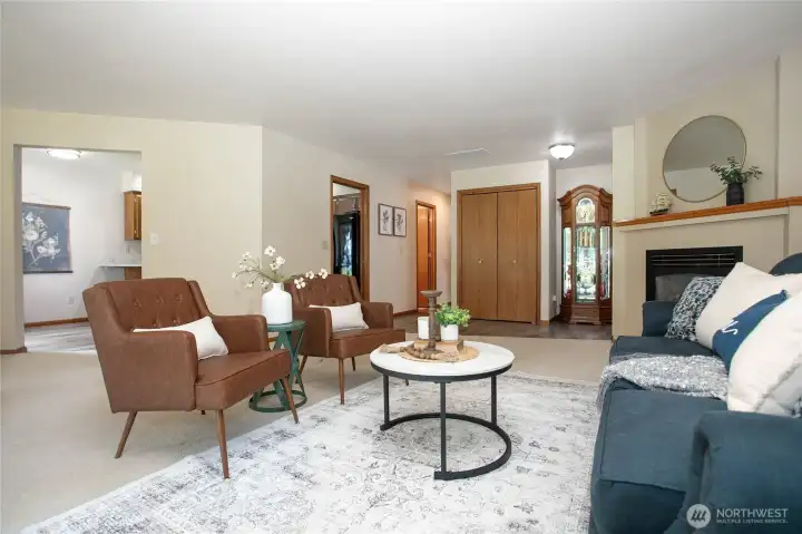 Nice open living room with neutral color palette. Kitchen has pocket door where it enters by fridge Nice open living room with neutral color palette. Kitchen has pocket door where it enters by fridge