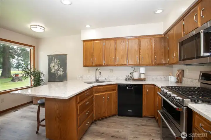 Kitchen has tons of cabinets, newer quartz counters, updated stainless steel double oven & micro, LVP flooring & cozy breakfast nook Kitchen has tons of cabinets, newer quartz counters, updated stainless steel double oven & micro, LVP flooring & cozy breakfast nook