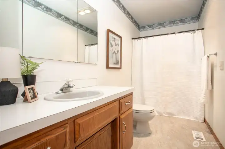 Full size guest bathroom with luxury vinyl tile flooring Full size guest bathroom with luxury vinyl tile flooring