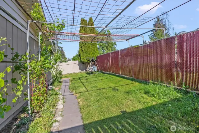 Groomed and private backyard with lush landscaping, mature plants, and space to relax or entertain. Ideal for summer BBQs, gardening, or unwinding in a peaceful outdoor setting.