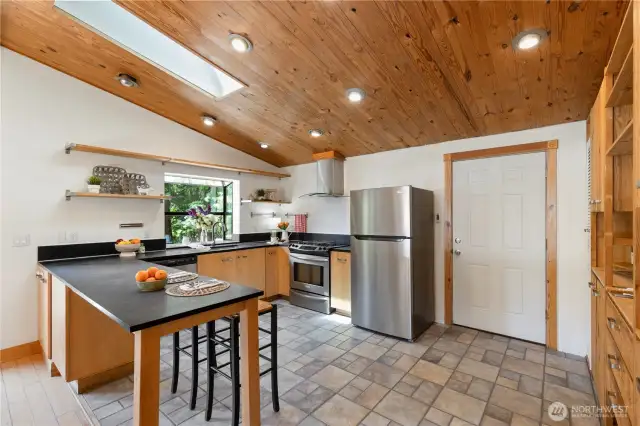 Large kitchen with 'Paper Stone' countertops and tile floors!