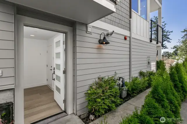 The front entry with the door to the garage to the right.